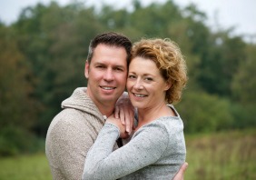 A smiling couple walking outdoors in the countryside